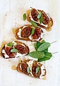 Toasted bread topped with goat's cheese, figs and sage leaves