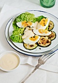 Salad with fried courgette sliced, eggs and mayonnaise