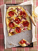 Tarte flambée with pepper sausage and onions