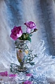 Violet roses in antique vase