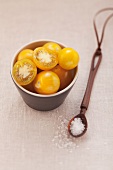 Yellow cherry tomatoes and a spoonful of salt