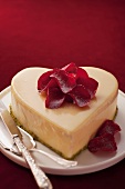 A heart-shaped cake decorated with rose petals for Valentines Day