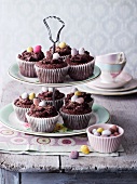 Chocolate cupcakes decorated with sugar eggs on a cake stand