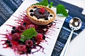 A tartlet with mascarpone-marsala cream, chocolate-amaretto dough and berries
