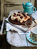 Luxurious chocolate cake with whipped cream and sweet cherries