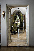 View of period furniture in dining room through open double doors