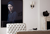Modern portrait of woman behind quilted back of elegant recamiere in postmodern living room