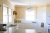 U shaped kitchen units with white base units in a light kitchen