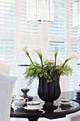 Floral arrangement with calla lilies on a living room table