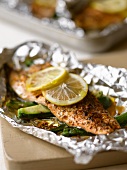 Trout with lemons and courgette in aluminium foil