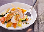 Guinea fowl breast on a warm vegetable and peach salad
