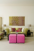 Elegant Art Deco-style living room - stools upholstered in pink and traditional sofa between table lamps on side tables