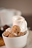 A bowl of white and brown sugar cubes