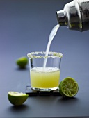 A lime drink being poured