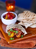 Pita bread filled with sausage, pepper and onions