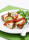 Toast topped with tomatoes, cheese and rocket