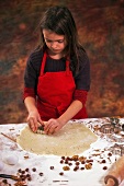 A girl cutting out biscuits