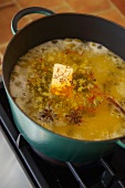Spicy rice with saffron and star anise being cooked (India)