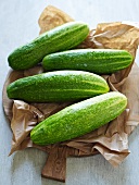 Four cucumbers on a piece of paper