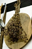 Dried herbs and an old wooden board hanging on a wall