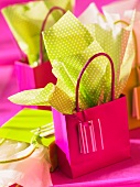 A green and pink gift bag with matching gift paper