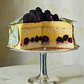 An orange and basil cake with blackberry, sliced