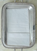 A napkin on a silver tray on a marble table