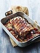 Roast pork and crackling with tomatoes and onions