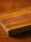 A chopping board on a wooden table