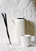 Vanilla pods, white jug and cup