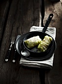 Chinese cabbage roulade with a mushroom filling a rashers of bacon