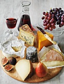 Various types of English cheese with fruit and wine