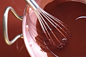 A whisk in liquid chocolate