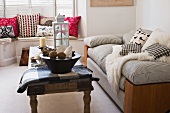 Comfortable seating area with striped sofa and window seat in bay window