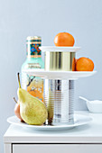 Fruit on a simple cake stand made of plates and tin cans