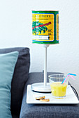 An original decorative lamp with a shade made from a colourful tin can