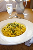 Spaghetti with Capers in a Butter Garlic Sauce; In a White Bowl