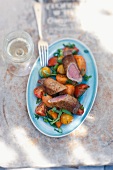 Saddle of lamb with a crispy bread crust and a tomato salad