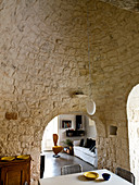 Esszimmer mit Gewölbedecke und Wand aus Naturstein in einem Trullo