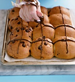 Hot cross buns decorated with chocolate sauce