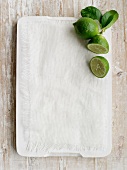 Limes on a chopping board