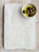 Preserved olives on a chopping board