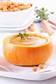 Cream of pumpkin soup in hollowed-out pumpkin