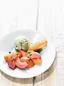 Poached peaches with pistachio ice cream and a financier