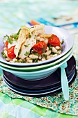 Fish fillet on bean salad with parsley and tomatoes