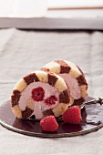 Black and white sponge roll with a raspberry filling