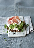 Wholemeal bread topped with cottage cheese, herbs and Parma ham