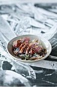 Duck breast on a bed of glass noodles with teriyaki sauce