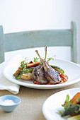 Lamb chops with red pepper sauce and vegetables