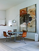 Shell chairs with leather covers and modern table in open-plan interior